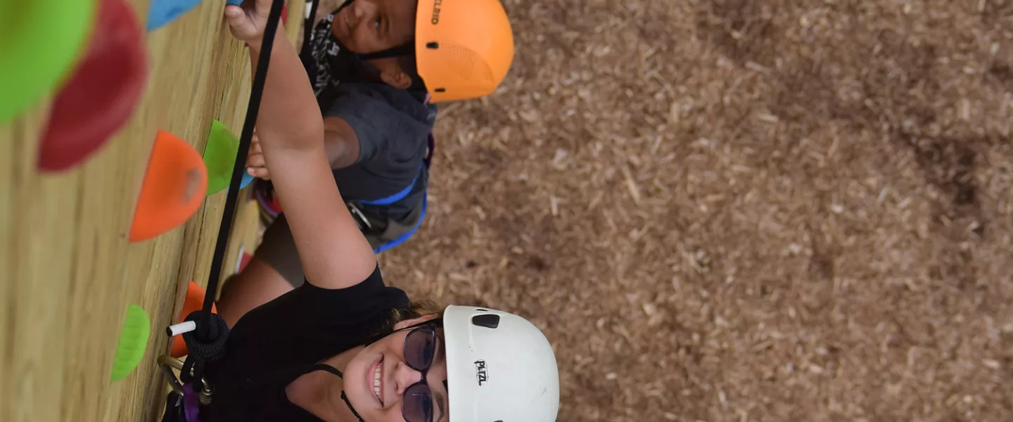 campers climbing the climbing wall