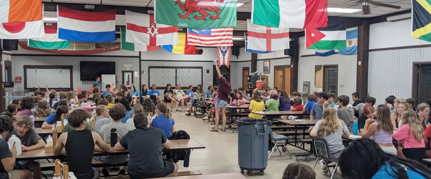 campers gathered at tables in dining hall