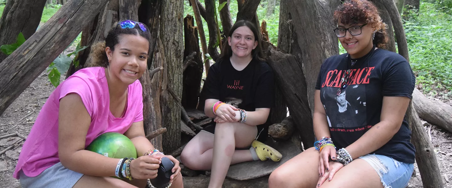 campers sitting in the woods