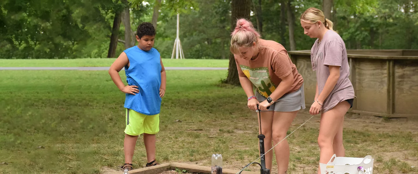 Campers and staff doing a science experiment