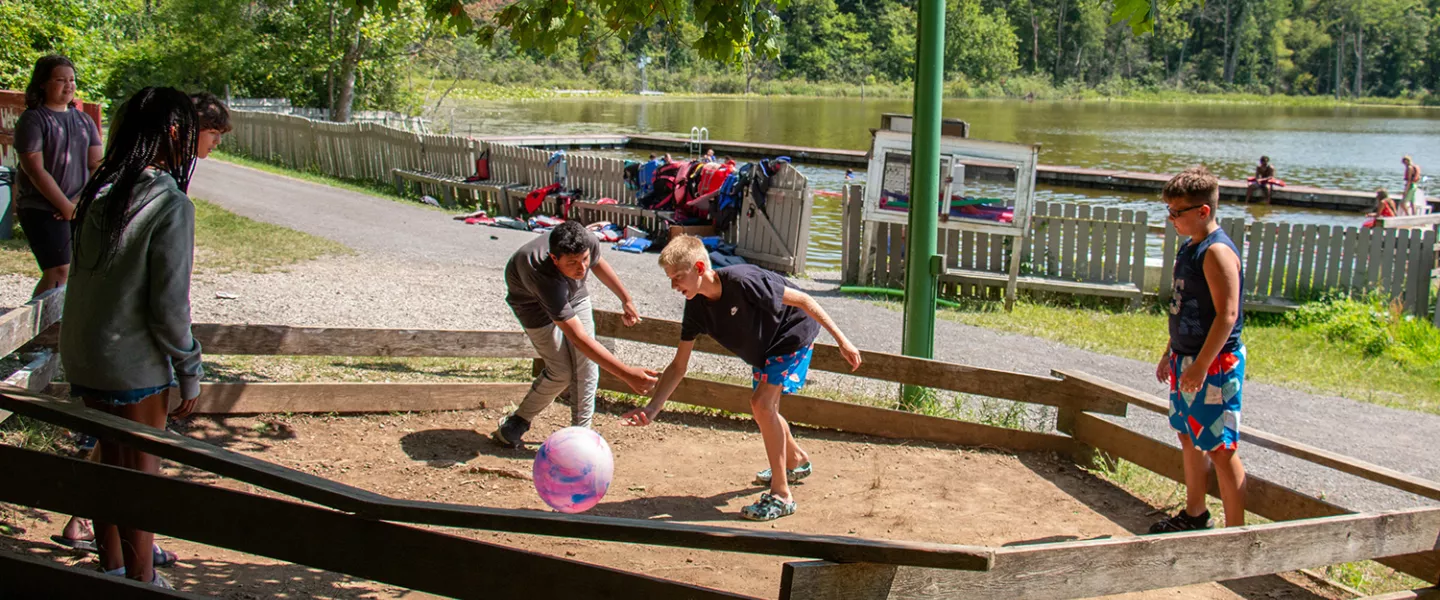 campers playing a game near the lake