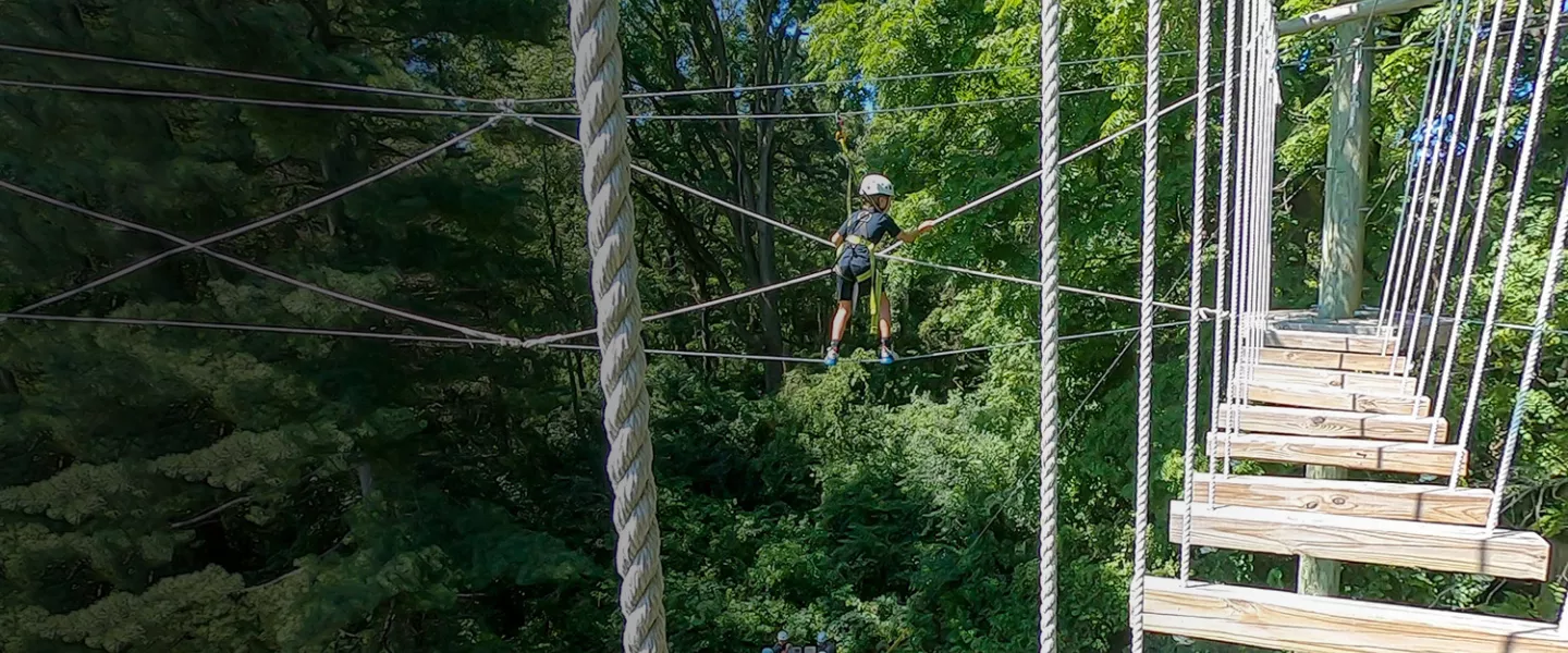 Camper on high ropes course