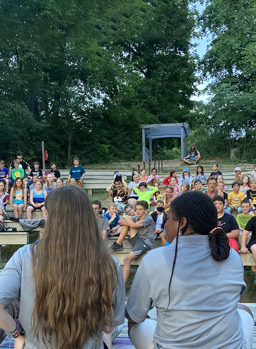 Camp staff leading campers at waterfront amphitheater