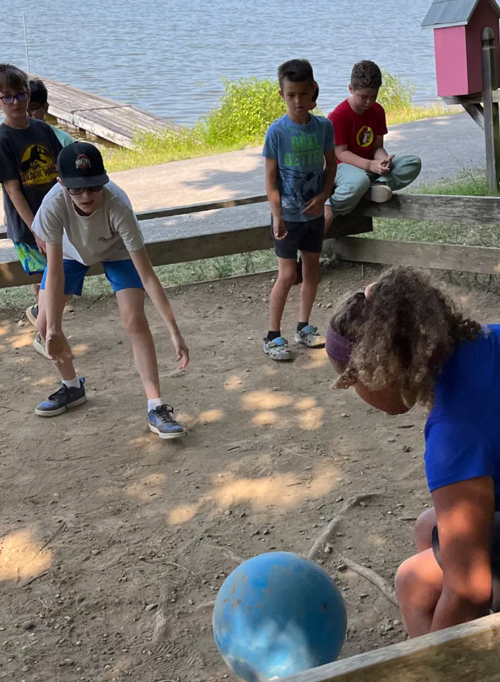 campers playing a game near the lake