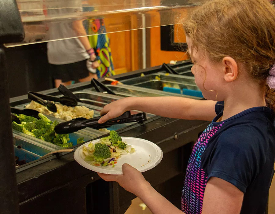 Camper choosing broccoli