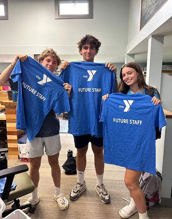 Campers holding t-shirts that read Future Staff