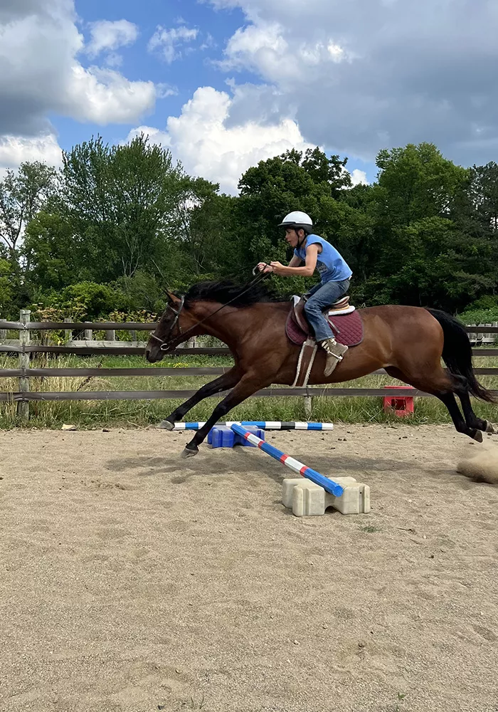 Camper jumping a horse