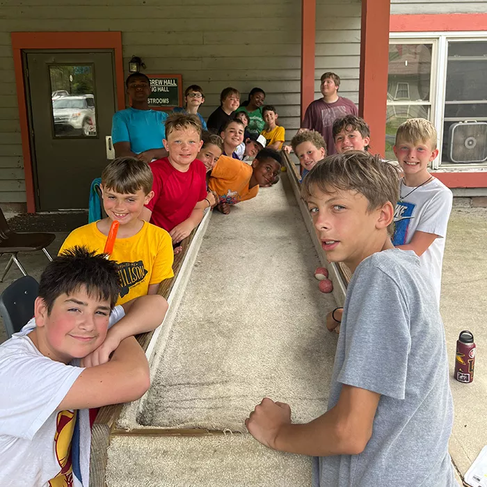 Campers posing at a game table